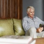 Man on couch with tablet